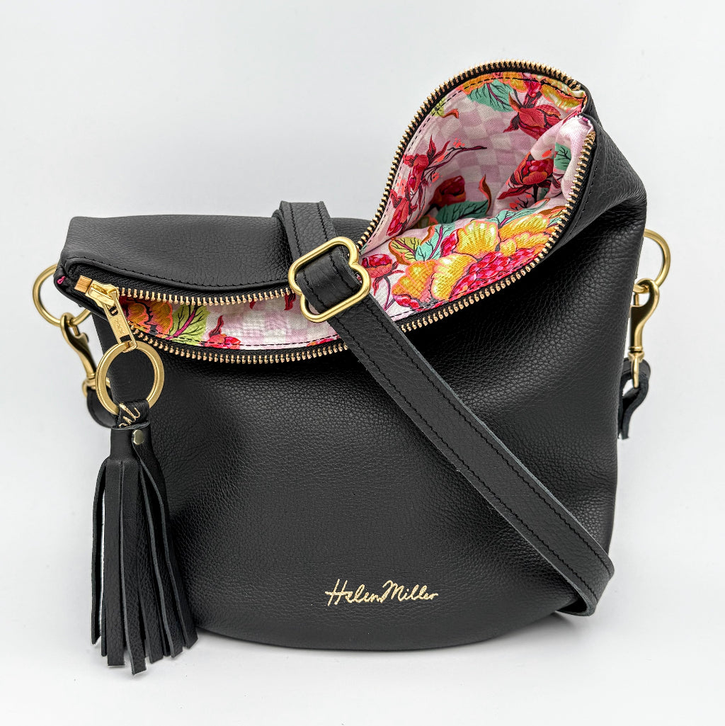 Black handbag with floral interior on a white background