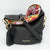 Black handbag with floral interior on a white background